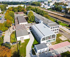 The photograph shows the school from a bird's eye view. You can see the old part with its irregular shape, and the new building.