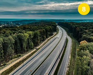 The photograph shows a fragment of the Racibórz-Pszczyna road running through Rybnik. You can see the new route with two lanes both ways and entries and exits. There are trees all around. A panorama is also visible. The photo was taken by Maciej Motylewski.